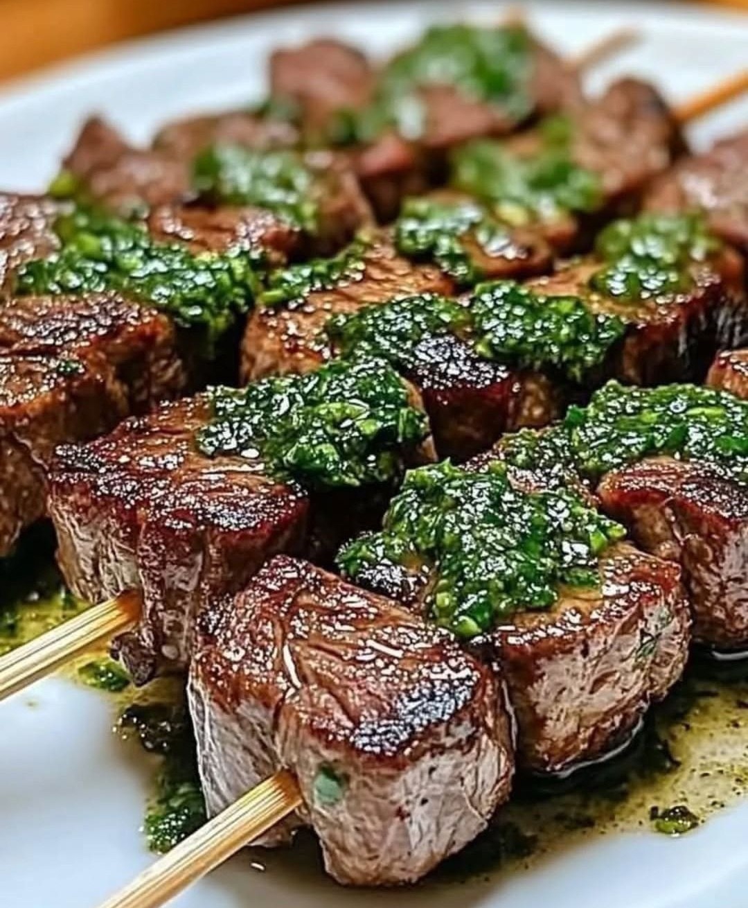 Grilled beef skewers with chimichurri sauce
