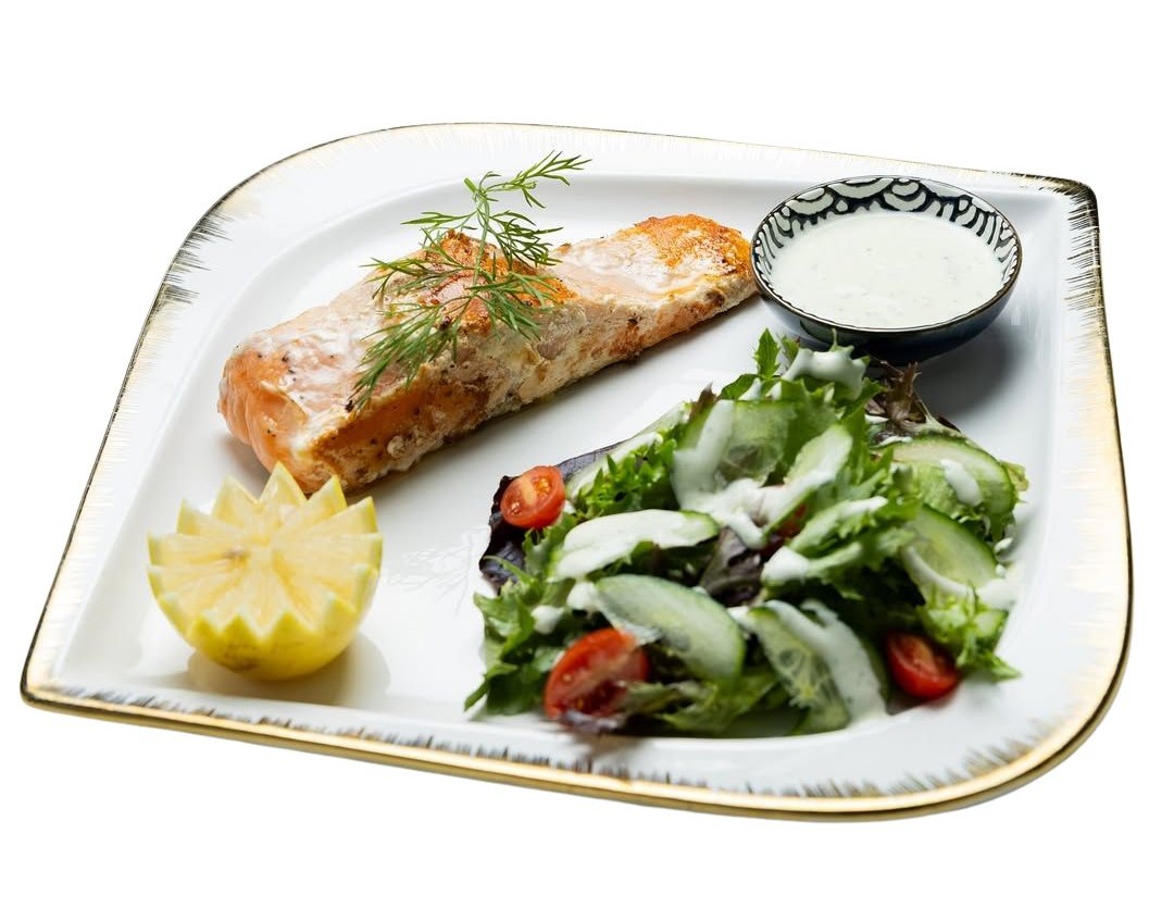 Grilled salmon with creamy garlic sauce and side salad